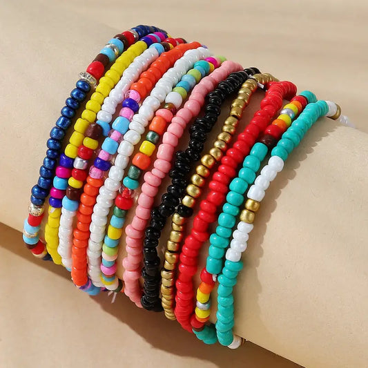 12 Colorful bead bracelets displayed.