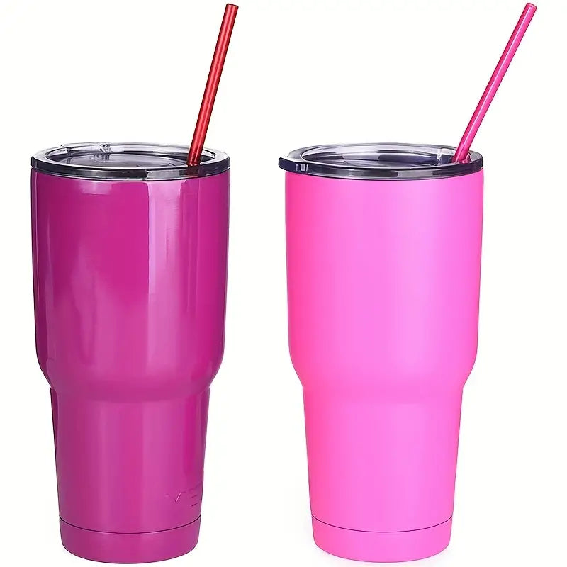 Two pink tumblers with resuseable plastic straws in them.